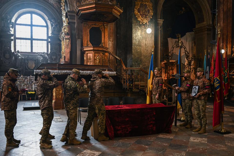 Ukrainian soldiers carry the coffin of the fallen soldier Evgeny Gulevich as they arrive at the Church of the Most Holy Apostles Peter and Paul in Lviv, Ukraine on April 10, 2023.