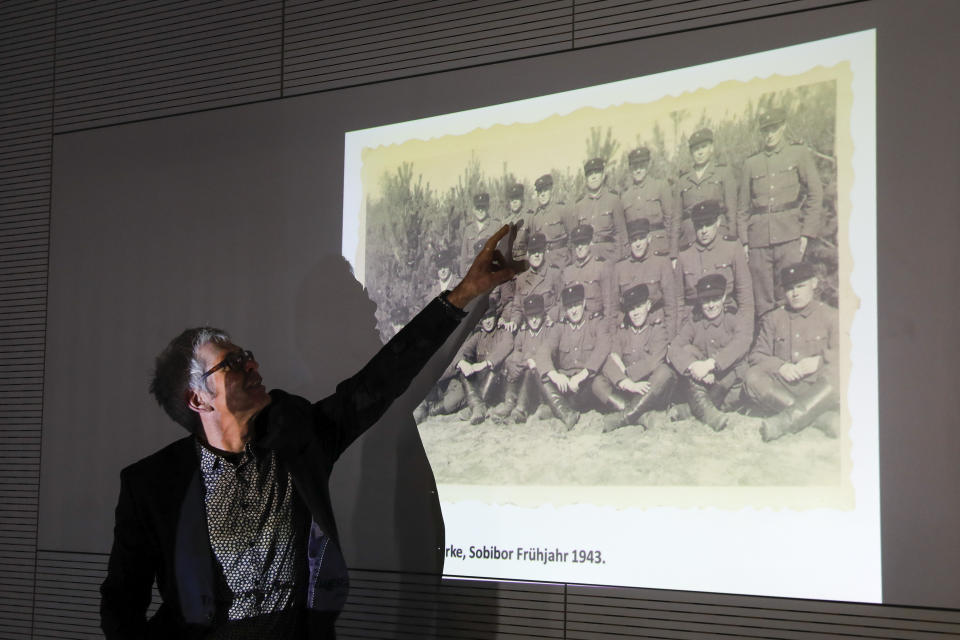 Historian Martin Cueppers points at a man, presumably former security guard John Demjanjuk, at the Nazi death camp Sobibor during a news conference of newly discovered photos from the Sobibor camp in Berlin, Germany, Tuesday, Jan. 28, 2020. (AP Photo/Markus Schreiber)