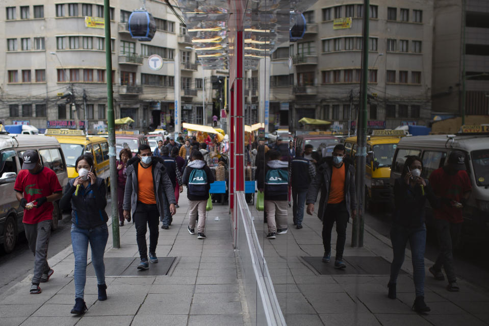 People wear face masks as a preventative measure against the spread of the new coronavirus in La Paz, Bolivia, Friday, March 20, 2020. (AP Photo/Juan Karita