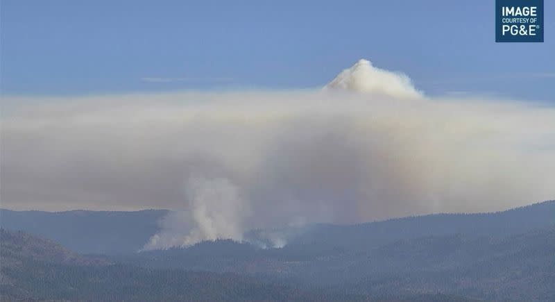 Smoke rises from hills as the Washburn Fire burns near Ahwahnee, California