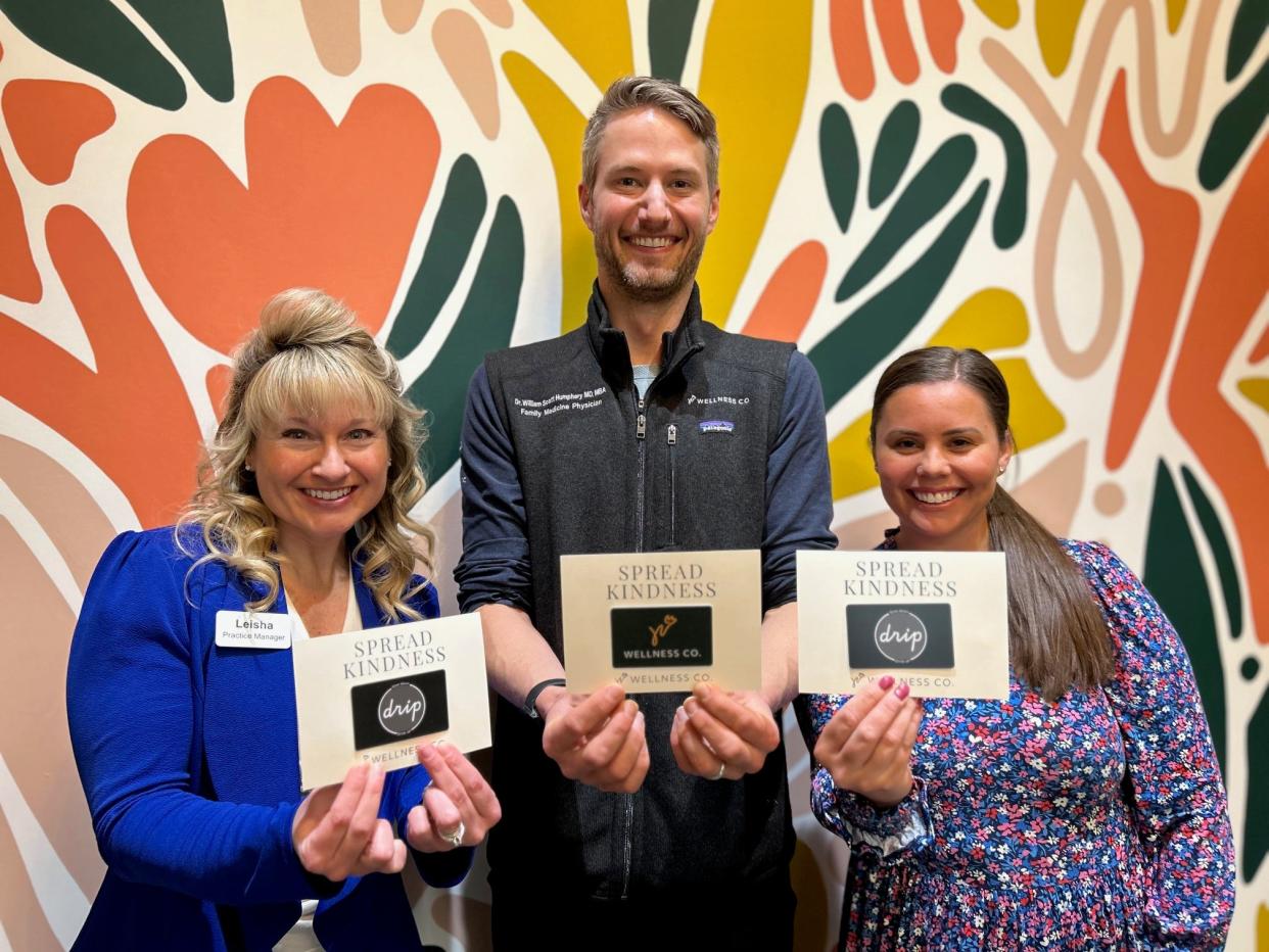 Leisha Eppink (left), William Scott Humphrey and Kelsey Prince are out to promote kindness in the community by handing out gift cards throughout the month of April at Wellness Co.