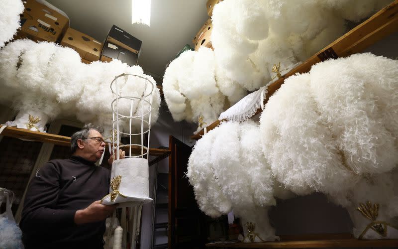 Louis Kersten arranges ostrich feather hats at his workshop in Binche