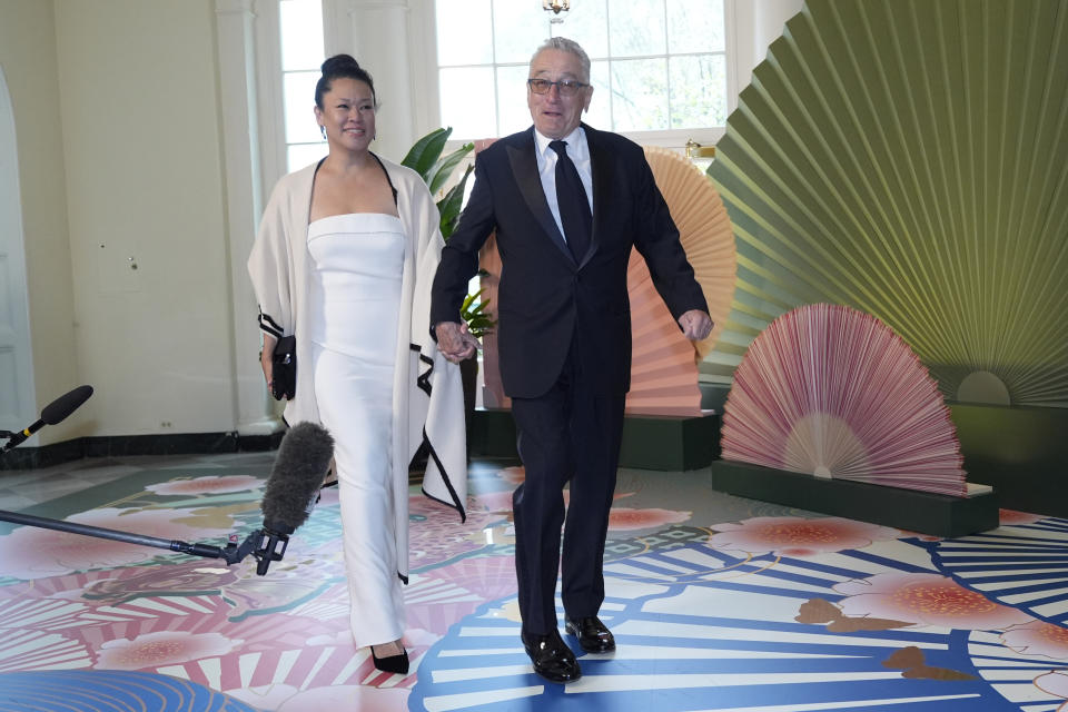 Robert De Niro and Tiffany Chen arrive at the Booksellers area of the White House for the State Dinner hosted by President Joe Biden and first lady Jill Biden for Japan's Prime Minister Fumio Kishida, and wife Kishida Yuko, Wednesday, April 10, 2024, in Washington. (AP Photo/Jacquelyn Martin)
