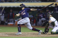 Minnesota Twins' Gary Sanchez watches his home run in front of Oakland Athletics catcher Sean Murphy during the sixth inning of a baseball game in Oakland, Calif., Tuesday, May 17, 2022. (AP Photo/Jed Jacobsohn)