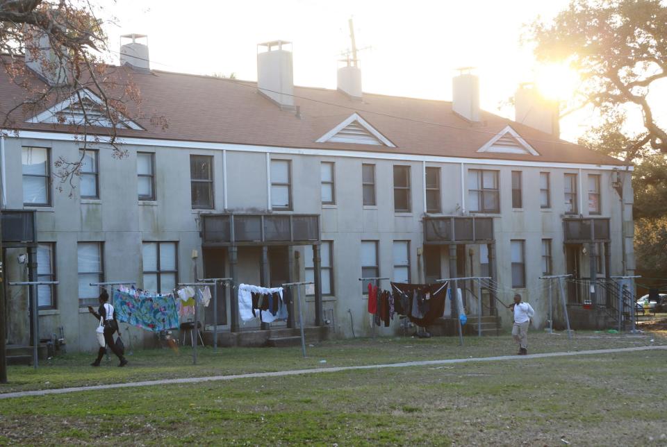 A family walks to their Yamacraw Village apartment.