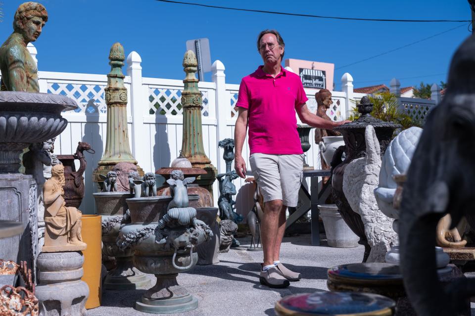 John Finger, owner of Palm Beach Vintage Home on Antique Row, poses for a picture among sculptures at his business on February 1, 2023, in West Palm Beach.