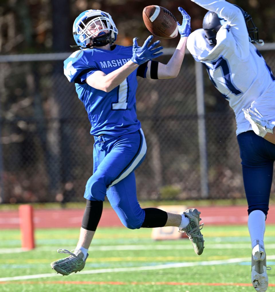 MASHPEE 11/23/23 Ryan Triveri of Mashpee makes a reception over Jack O'Brien of Sandwich for a touchdown. football Ron Schloerb / Cape Cod Times