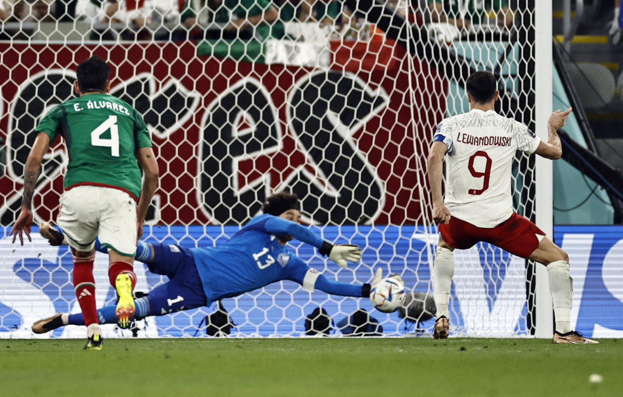 Soccer Football - FIFA World Cup Qatar 2022 - Group C - Mexico v Poland - Stadium 974, Doha, Qatar - November 22, 2022  Poland's Robert Lewandowski has his penalty saved by Mexico's Guillermo Ochoa REUTERS/Hamad I Mohammed