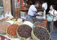 A Syrian woman buys seeds at a market in old Damascus, September 10, 2013. REUTERS/Khaled al-Hariri