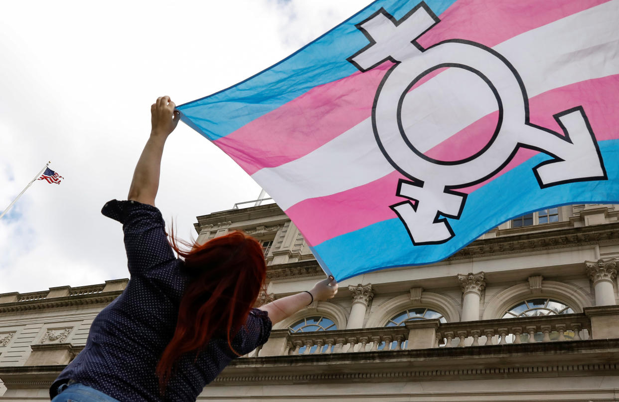 A person holds up a transgender flag during rally in 2018. Now, 1.6 percent of Americans identify as trans, Pew Research Center has found. (Reuters/Brendan McDermid)