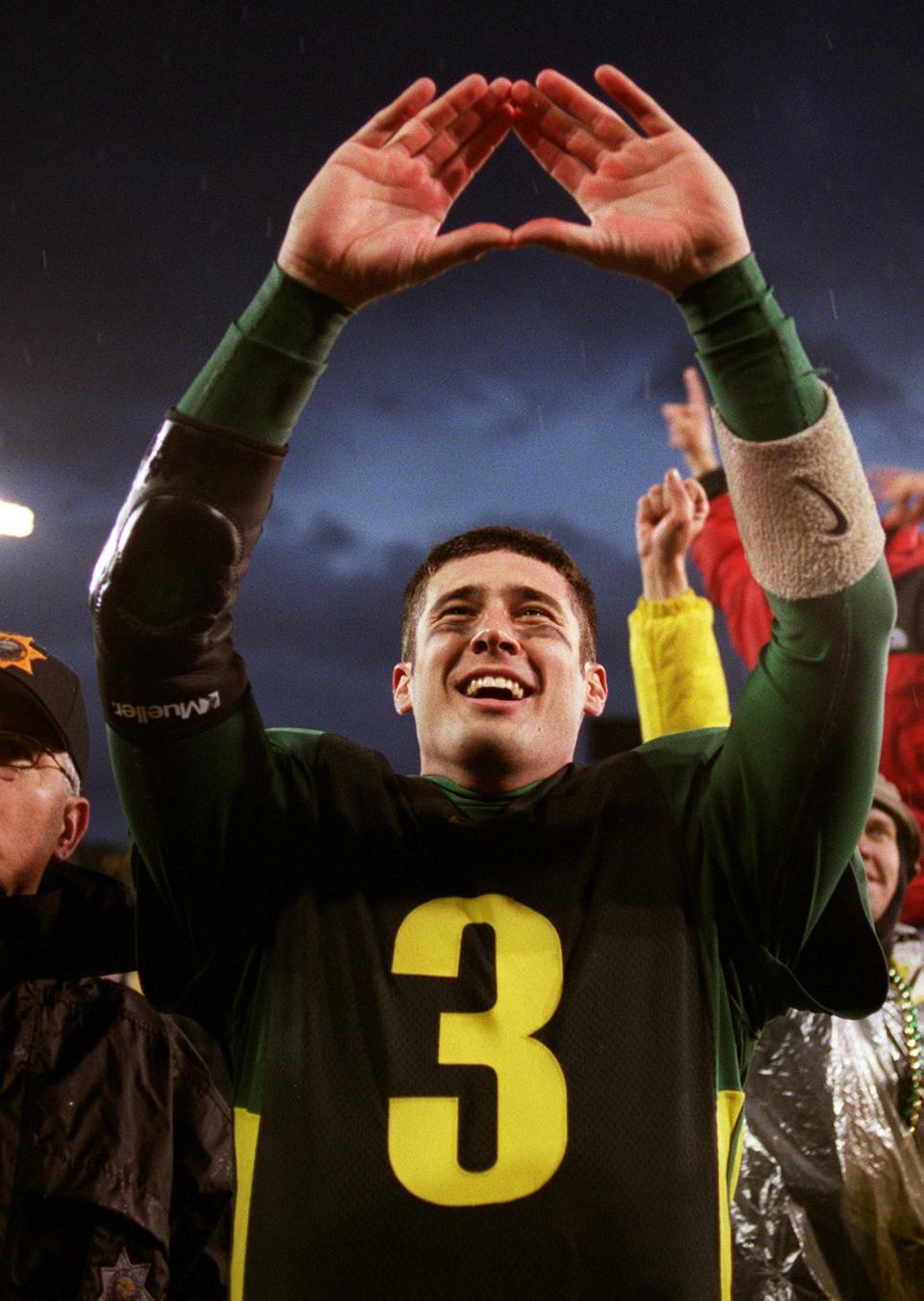 2001 — Oregon's Joey Harrington makes the sign of the letter O to fans after the 17-14 victory.