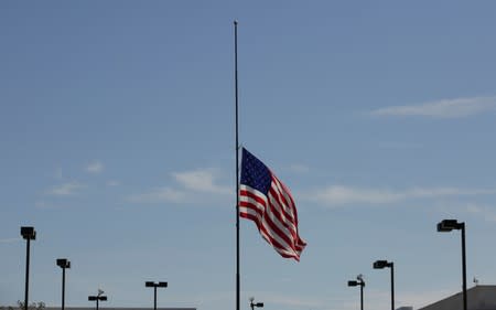 The U.S. flag is seen at half-mast, near the site of a mass shooting where 20 people lost their lives at a Walmart in El Paso