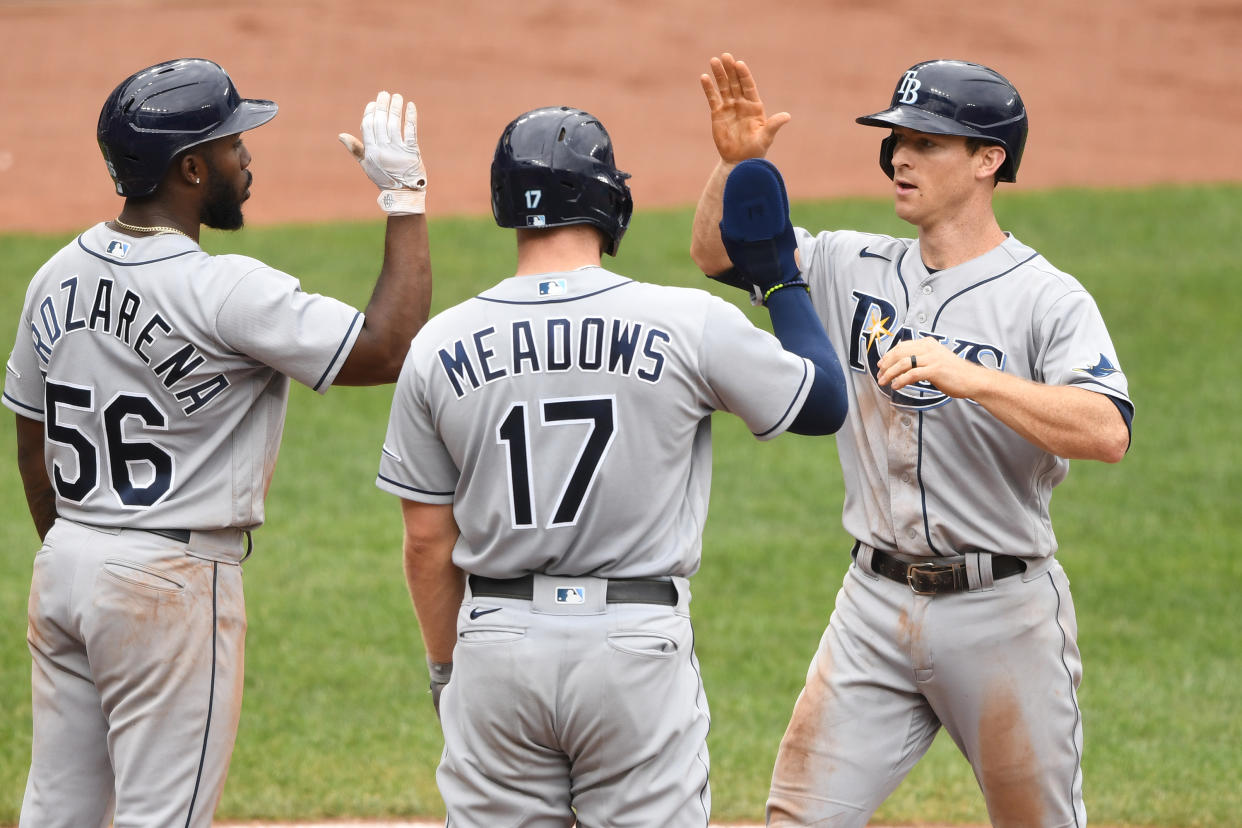 Joey Wendle of the Tampa Bay Rays celebrates with teammates Randy Arozarena and Austin Meadows after hitting a grand slam in a win over the Orioles. (Photo by Mitchell Layton/Getty Images)