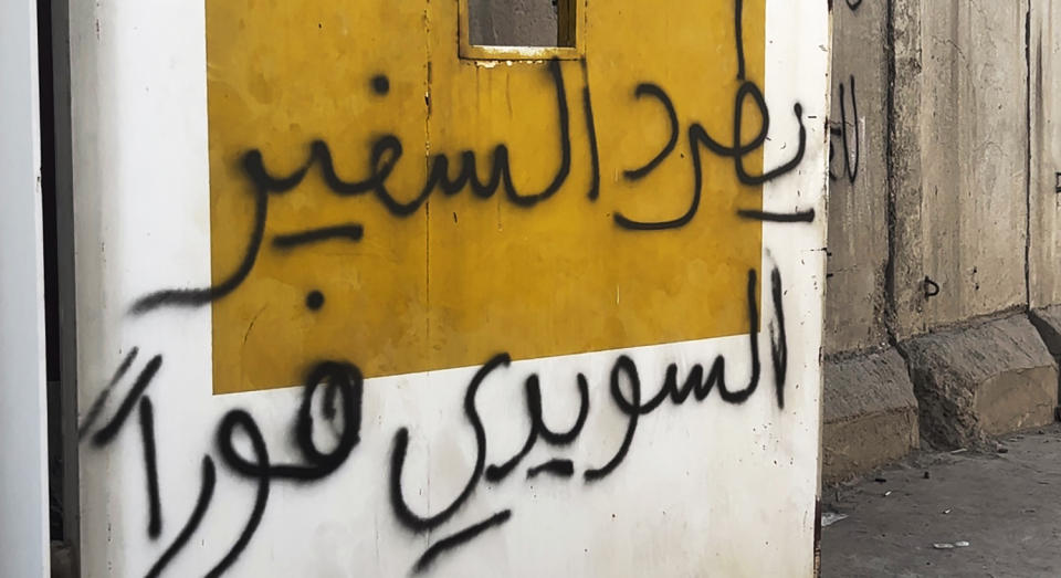 Writing on the walls saying ""Expel the Swedish ambassador immediately," is seen as hundreds of followers of the influential Iraqi Shiite cleric and political leader Muqtada Sadr stand outside the Swedish embassy in Baghdad, Iraq, Thursday, June 29, 2023, in protest of the burning of a Quran in Sweden. An Iraqi security official has said the Swedish embassy was evacuated by security forces after the protesters breached the building, raising pictures of Sadr and flags of his militia, the Mahdi Army. (AP Photo/Ali Jabar)