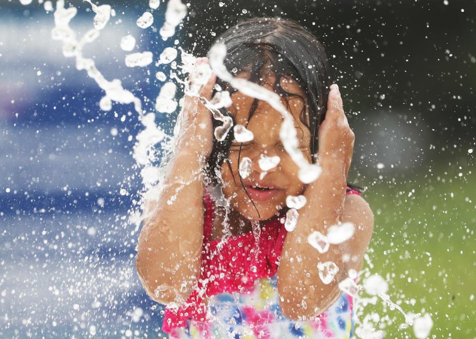 Valentina Sosa, 4, enjoys the water park at Veterans Park in Lehigh Acres on Tuesday May, 14, 2019. Temperatures were hovering in the mid 80's. 