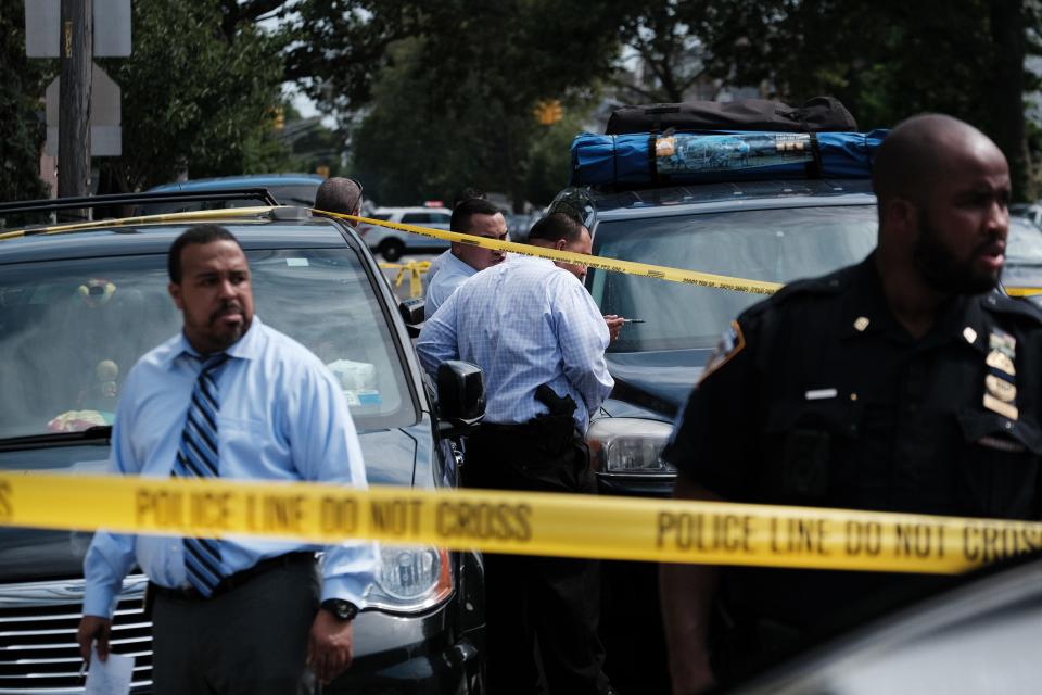 Police converge on the scene of a shooting in Brooklyn, one of numerous during the day, on July 14, 2021, in New York City. State officials have said they would offer 4,000 summer and full-time jobs with training for youth in high-crime neighborhoods in an effort to reduce violence.