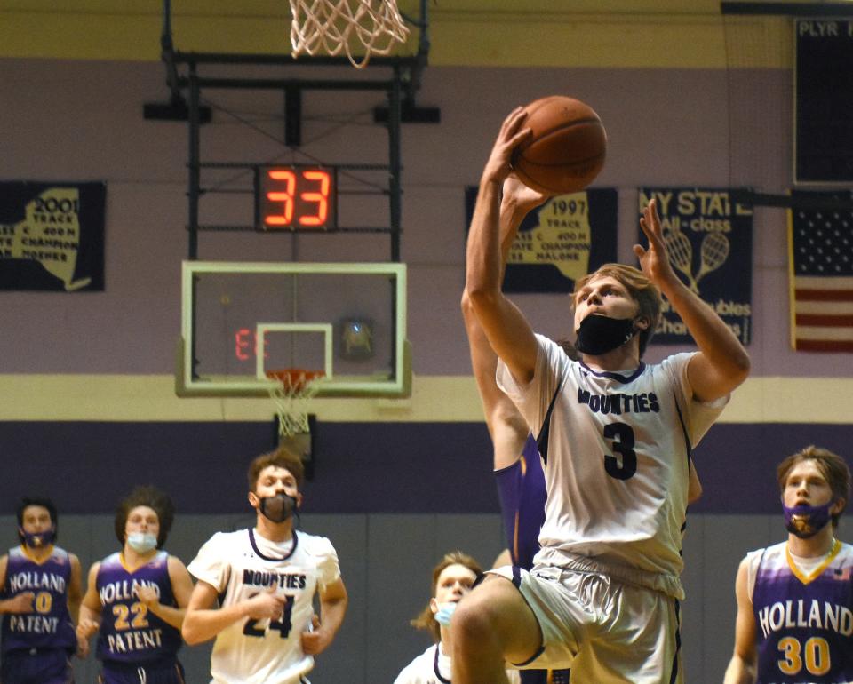 Logan Frederick (3) scores with a layup during a 16-2 Little Falls run in the first quarter of Friday's game against Holland Patent.