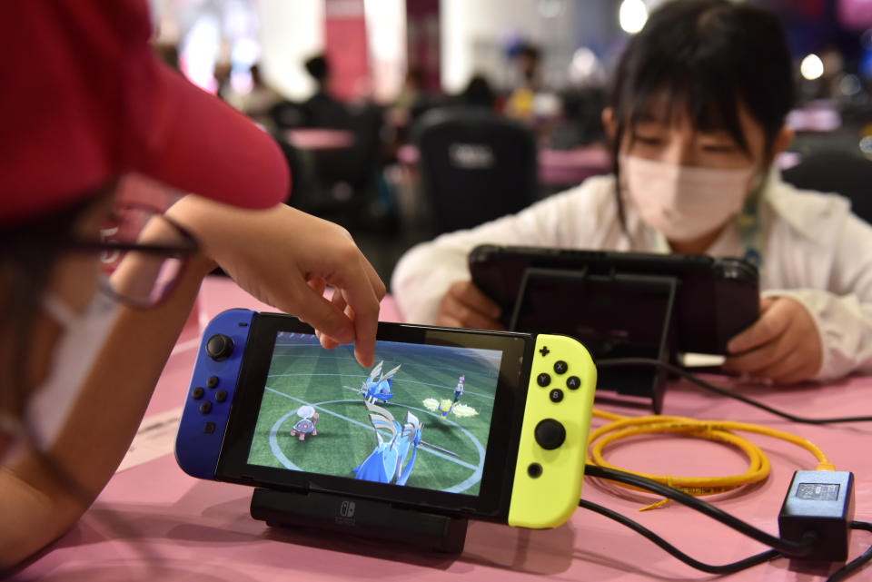 LONDON, ENGLAND - AUGUST 18: Young children play Pokemon on Nintendo Switch consoles during the 2022 Pokémon World Championships at ExCel on August 18, 2022 in London, England. For the first time in history, the championship event is being held outside of North America, London Excel will host the competition on August 18–21. Some of the best Pokémon players from around the will compete in Pokémon TCG, the Pokémon Sword and Pokémon Shield video games, Pokémon GO, Pokémon UNITE, and Pokkén Tournament DX. Half a million dollars in prizes, the title of Pokémon World Champion, and return invitations for the following year's Worlds are up for grabs. (Photo by John Keeble/Getty Images)