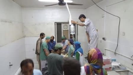 Afghan (MSF) surgeons work inside a Medecins Sans Frontieres (MSF) hospital after an air strike in the city of Kunduz, Afghanistan in this October 3, 2015 MSF handout photo. REUTERS/Medecins Sans Frontieres/Handout via Reuters