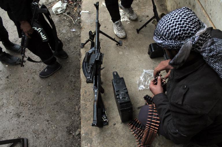 A rebel fighter checks his ammunition in the northeastern Syrian city of Deir Ezzor on December 31, 2013