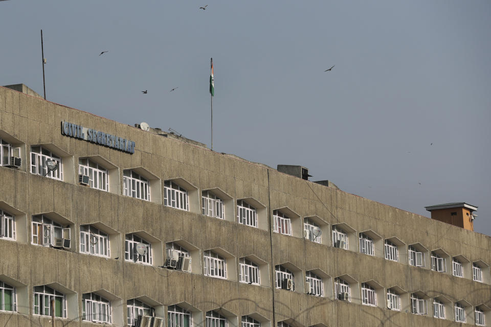 Indian National flag is hoisted on the government civil secretariat building in Srinagar, Indian controlled Kashmir, Thursday, Oct. 31, 2019. Kashmir's local flag, which used to flutter along with India's flag, has already been removed after New Delhi early August stripped the disputed Himalayan region of Kashmir from its semiautonomous status and downgraded its statehood, formally taking direct control over the region on Thursday. (AP Photo/ Dar Yasin)