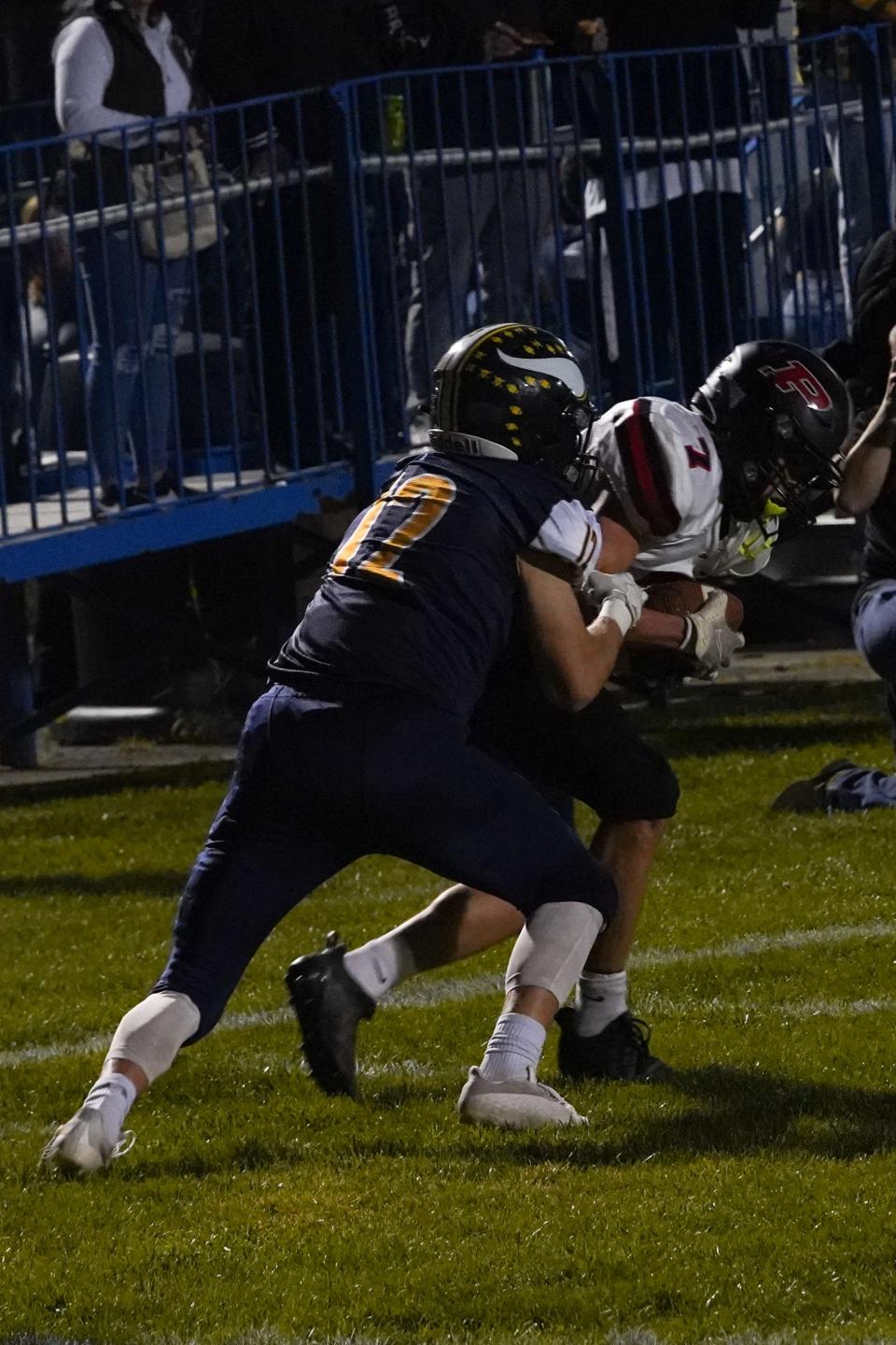 Pleasant receiver Cadence Varner hauls in a pass against River Valley defender Brayden Boyd during a football game last season at River Valley.