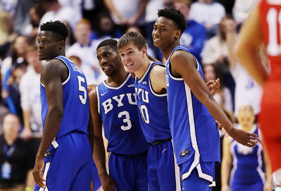 BYU’s forward Gideon George (5), guard Rudi Williams (3), guard Dallin Hall (30), and guard Jaxson Robinson (2) celebrate as BYU defeats Utah at the Marriott Center in Provo on Saturday, Dec. 17, 2022. BYU won 75-66.