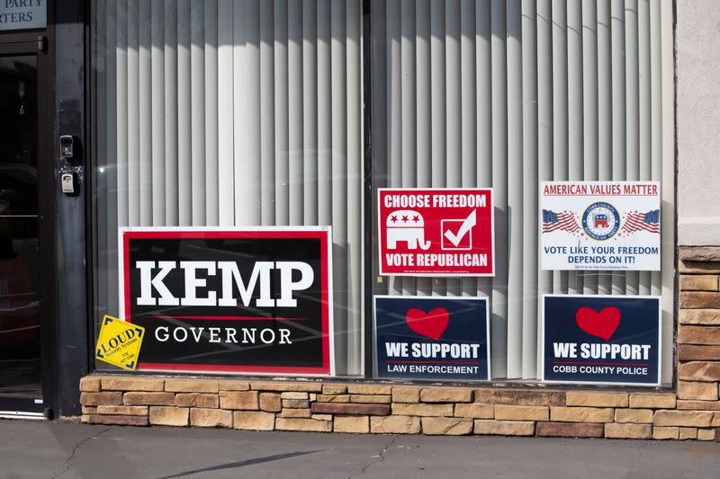 Political signs are displayed in the window front of the Cobb County Republicans headquarters, in Marietta