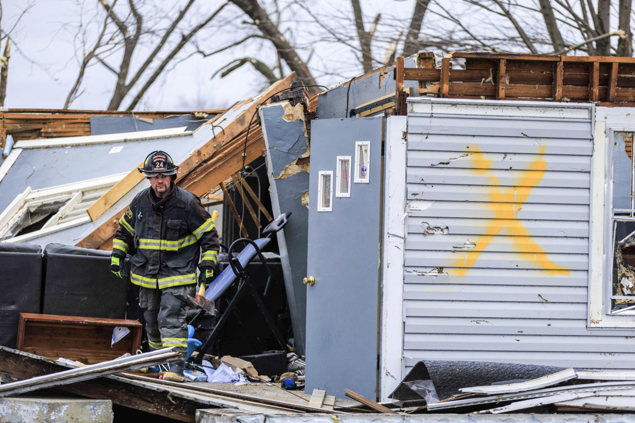 A firefighter helps with search and rescue operations after a tornado in Sullivan, Ind., on April 1, 2023. (Jeremy Hogan / SOPA Images/Sipa USA via AP)