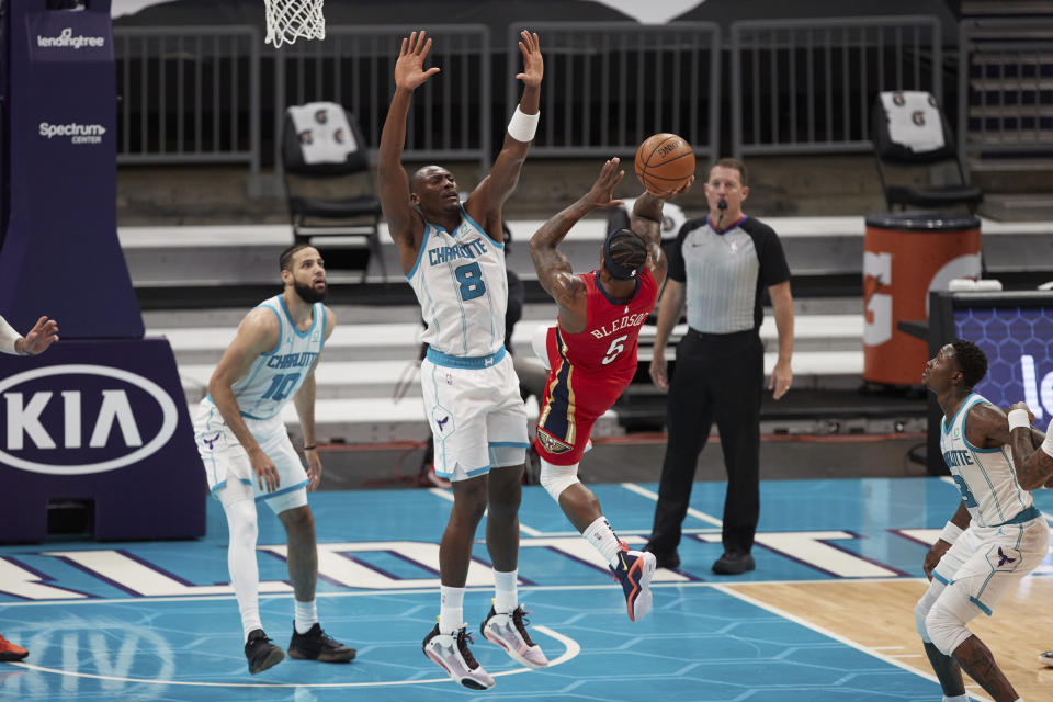 New Orleans Pelicans guard Eric Bledsoe (5) tries to shoot over Charlotte Hornets center Bismark Biyombo (8) during the second half of an NBA basketball game Sunday, May 9, 2021, in Charlotte, N.C. (AP Photo/Brian Westerholt)