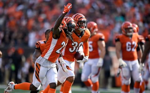 Dre Kirkpatrick #27 of the Cincinnati Bengals and Jessie Bates #30 celebrate after Bates intercepted a pass from Ryan Tannehill #17 of the Miami Dolphins during the fourth quarter at Paul Brown Stadium  - Credit: (Bobby Ellis/Getty Images)