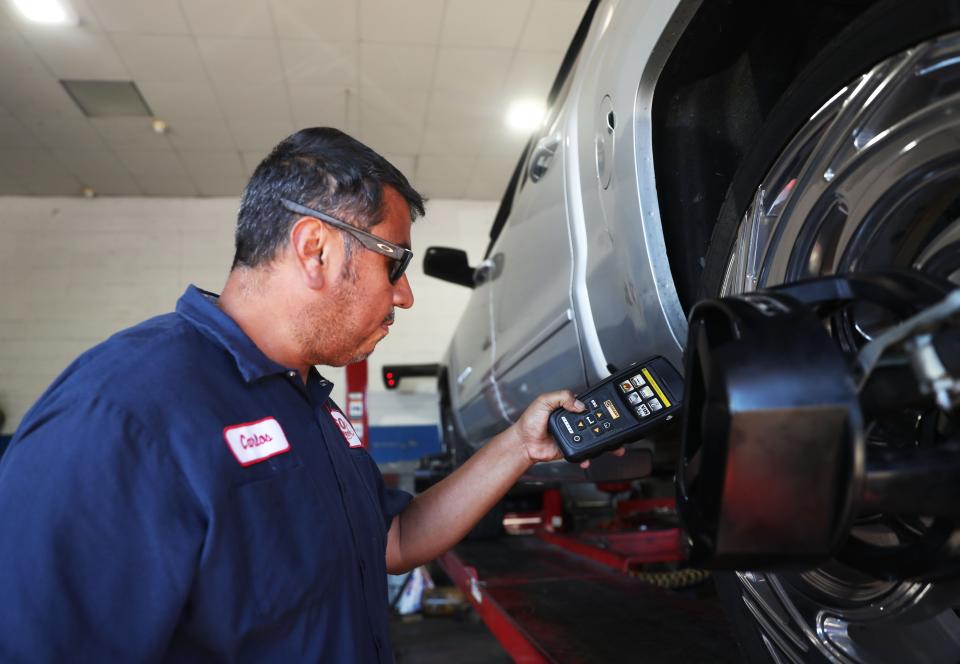 Carlos Villalpando inspects a truck in need of repair on Monday, Oct. 3, 2022 at 360 Wheel Repair in Memphis.