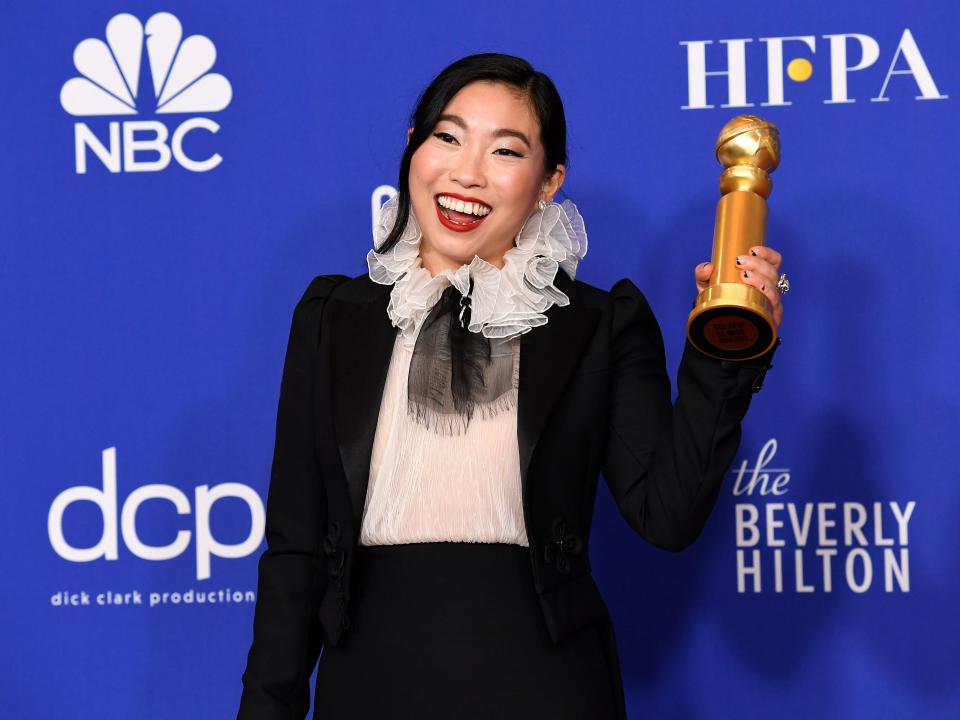 Awkwafina poses with her award at the Golden Globes in 2020.