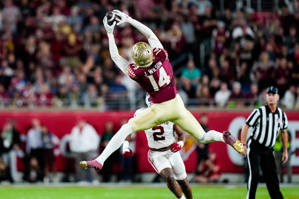 Dec 29, 2022; Orlando, Florida, USA; Florida State Seminoles wide receiver Johnny Wilson (14) catches a pass against the Oklahoma Sooners during the second half in the 2022 Cheez-It Bowl at Camping World Stadium. Mandatory Credit: Rich Storry-USA TODAY Sports