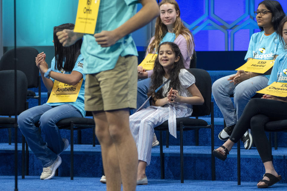 Girls who already spelled their words correctly cheer for a speller after he got his word correct during competition at the Scripps National Spelling Bee, in Oxon Hill, Md., Tuesday, May 28, 2024. (AP Photo/Jacquelyn Martin)