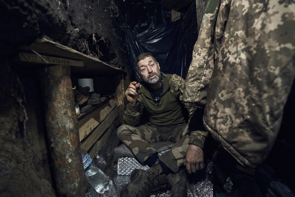 A Ukrainian soldier sits in a trench at the frontline near Bakhmut in the Donetsk region, Ukraine, Friday, May 26, 2023. (AP Photo/Libkos)