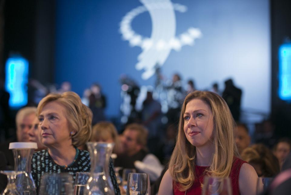 Former U.S. Secretary of State and former U.S. first lady Hillary Clinton (L) and daughter Chelsea Clinton watch the discussions on stage at the Clinton Global Initiative 2013 (CGI) in New York September 24, 2013. REUTERS/Adrees Latif (UNITED STATES - Tags: POLITICS)