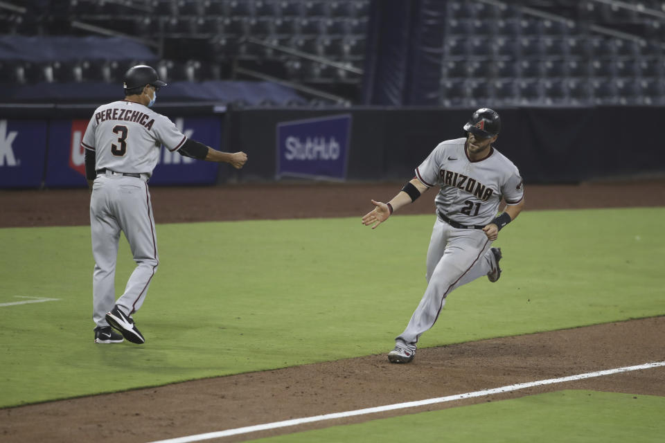 Arizona Diamondbacks' Stephen Vogt is congratulated by third base coach Tony Perezchica after hitting a home run against the San Diego Padres during the sixth inning of a baseball game Saturday, Aug. 8, 2020, in San Diego. (AP Photo/Derrick Tuskan)