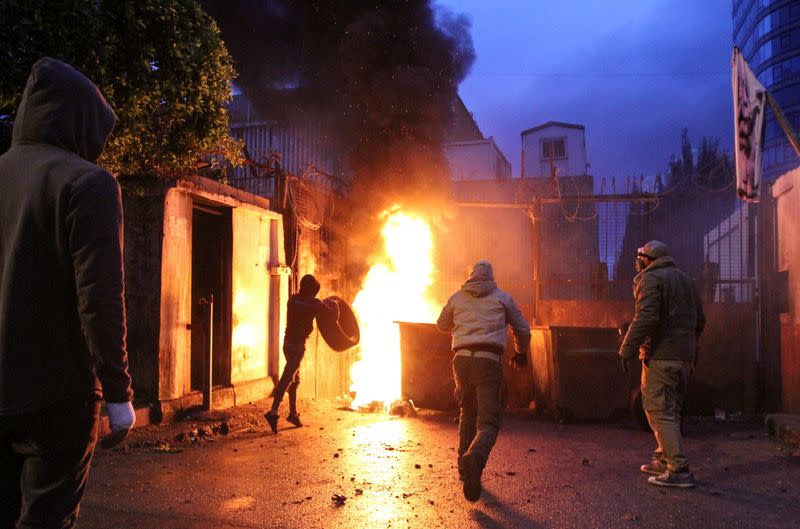 Demonstrators set fire near the government Serail building, during a protest in Tripoli