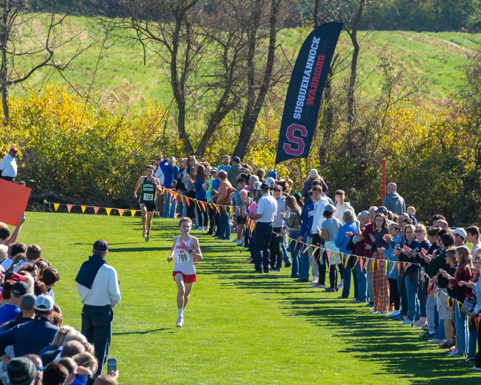 Susquehannock’s Matt O’Brien pushes to stay ahead of Central Dauphin’s Timothy Roden on the final straightaway in the District 3 Class 3A boys’ race at Big Spring High School on Saturday, Oct. 29, 2022.