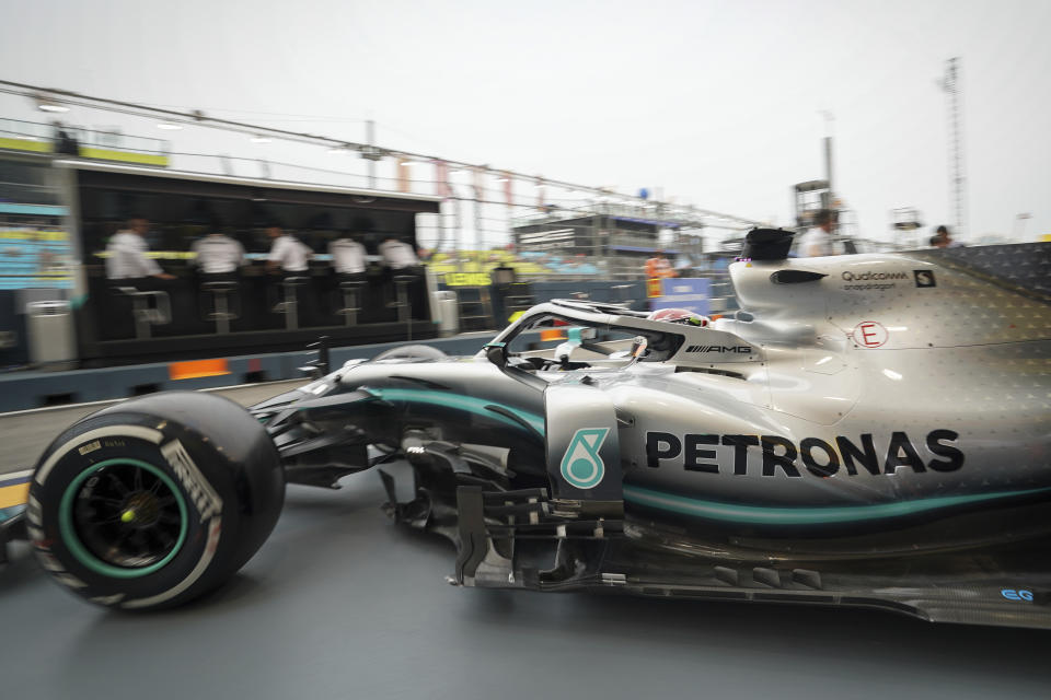 Mercedes driver Lewis Hamilton of Britain pulls out of his garage during the first practice session at the Marina Bay City Circuit ahead of the Singapore Formula One Grand Prix in Singapore, Friday, Sept. 20, 2019. (AP Photo/Vincent Thian)