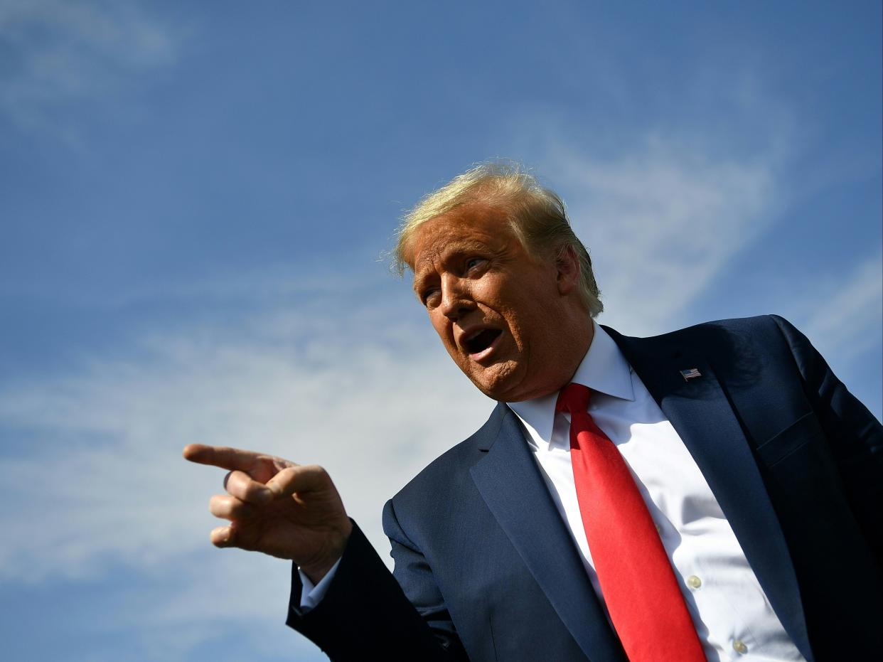 S President Donald Trump speaks to members of the media upon arrival at Phoenix Sky Harbor International Airport in Phoenix, Arizona on October 19, 2020. (AFP via Getty Images)