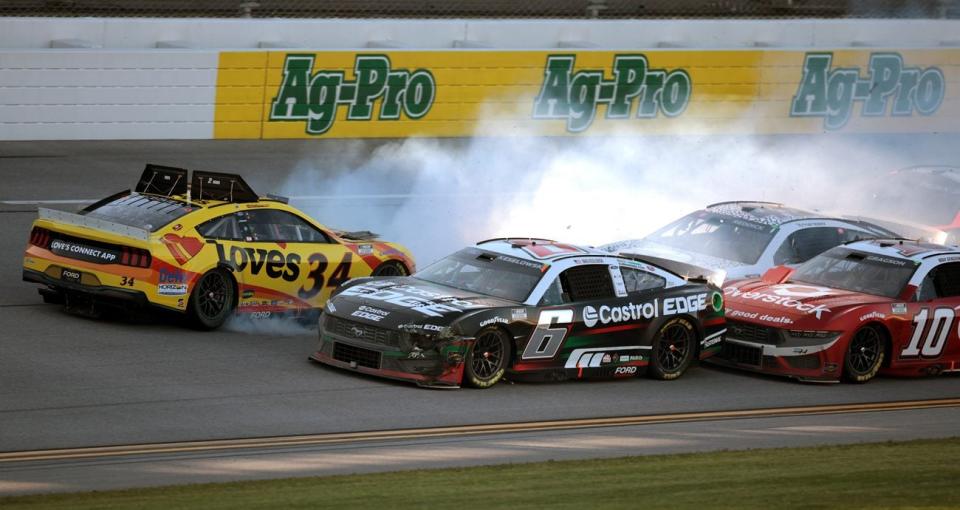 Michael McDowell spins in the tri-oval on the final lap of the NASCAR Cup Series race at Talladega in front of Brad Keselowski and Tyler Reddick.