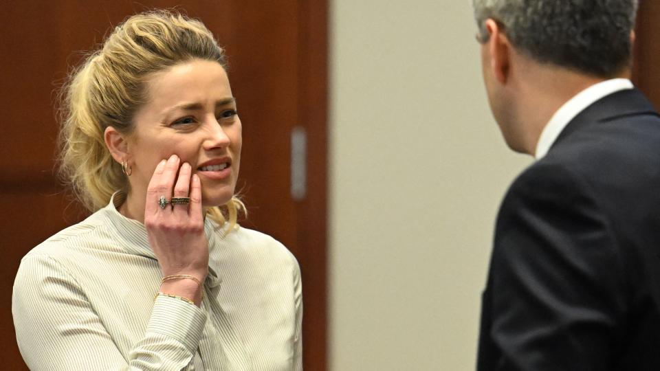 US actress Amber Heard looks on during a trial in the Fairfax County Circuit Courthouse in Fairfax, Virginia, on April 19, 2022. - US actor Johnny Depp is suing ex-wife Amber Heard for libel after she wrote an op-ed piece in The Washington Post in 2018 referring to herself as a public figure representing domestic abuse. (Photo by JIM WATSON / POOL / AFP) (Photo by JIM WATSON/POOL/AFP via Getty Images)