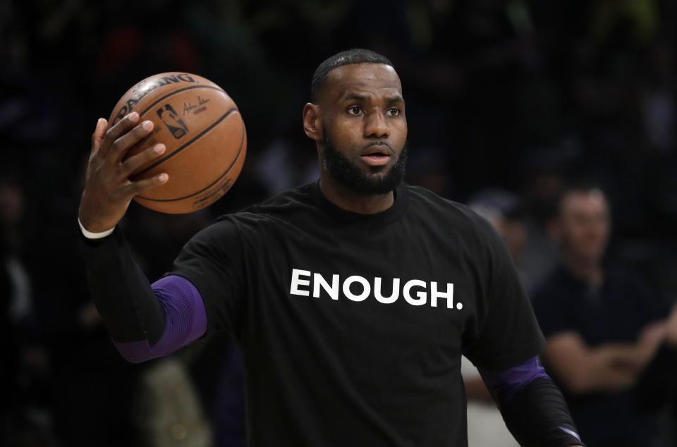 Los Angeles Lakers’ LeBron James wears a T-shirt for the 12 victims of Wednesday night’s shooting at a bar in Thousand Oaks, Calif., before an NBA basketball game against the Atlanta Hawks Sunday, Nov. 11, 2018, in Los Angeles. (AP Photo/Marcio Jose Sanchez)