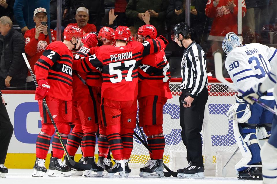 Red Wings defenseman Moritz Seider celebrates with teammates after scoring in the first period on Monday, Nov. 28, 2022, at Little Caesars Arena.