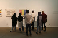 Visitors look at artworks by the American artist Sol Lewitt while visiting a 19th and 20th-century American and European minimalist and conceptual masterpieces show at the Tehran Museum of Contemporary Art in Tehran, Iran, Tuesday, Aug. 2, 2022. Some of the world’s most prized works of contemporary Western art have been unveiled for the first time in decades — in Tehran. (AP Photo/Vahid Salemi)