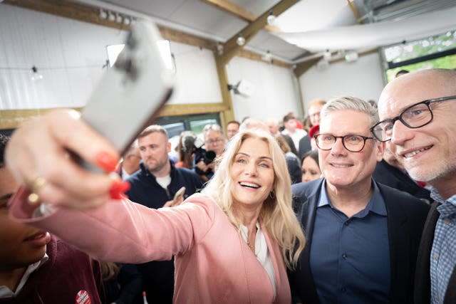 Former Danish prime minister Helle Thorning-Schmidt, left, takes a selfie with Labour Party leader Sir Keir Starmer and her husband, Stephen Kinnock (far right), at West Regwm Farm in Whitland, Carmarthenshire, after Sir Keir addressed supporters on the final day of campaigning for Thursday's General Election 