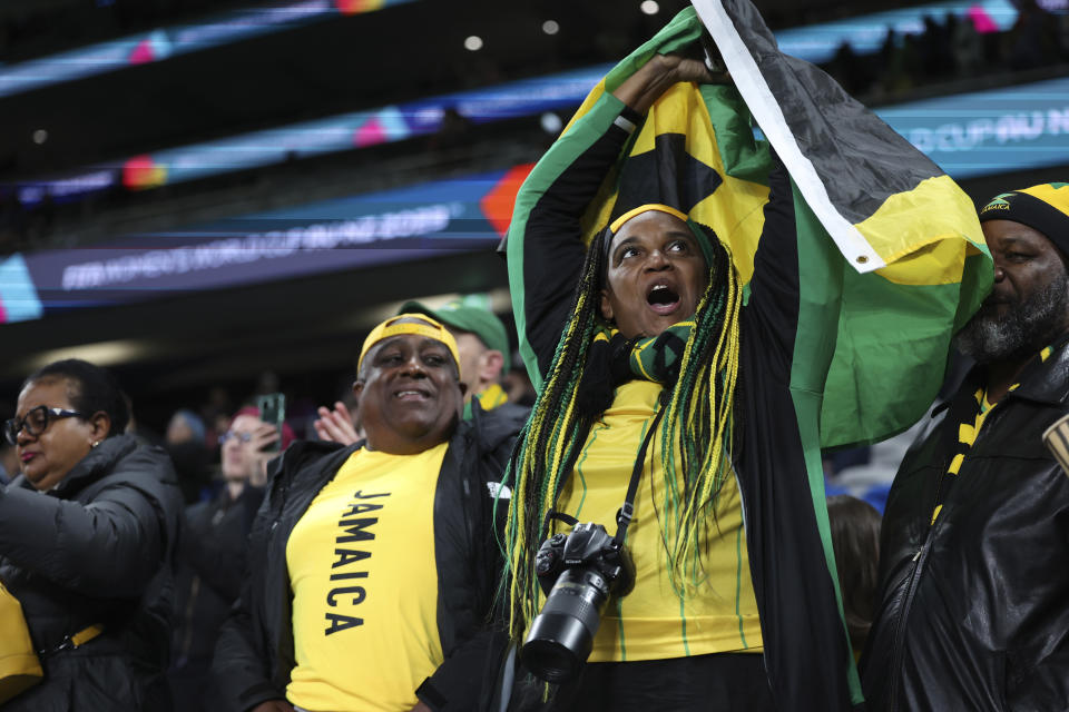 Jamaican fans celebrate after their team drew 0-0 during the Women's World Cup Group F soccer match between France and Jamaica at Sydney Football Stadium in Sydney, Australia, Sunday, July 23, 2023. (AP Photo/Sophie Ralph)
