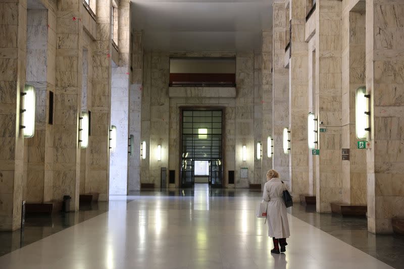 Woman walks along corridor at Milan Court of Justice